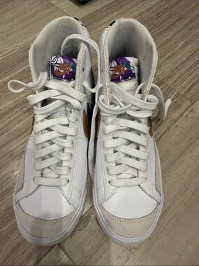 Nike White High-Top Sneakers with Purple Accent and Gold Swoosh